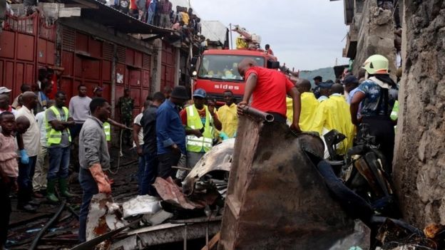 Rescuers and civilians gather at the site where a Dornier 228-200 plane operated by local company Busy Bee crashed into a densely populated neighborhood in Goma, eastern Democratic Republic of Congo November 24, 2019.
