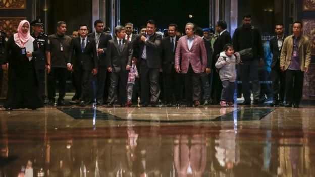 Malaysia's Foreign Minister Anifah Aman (6-R) walks with the nine Malaysian citizens after they arriving at the Bunga Raya complex, Kuala Lumpur International airport in Sepang, Malaysia, 31 March 2017.