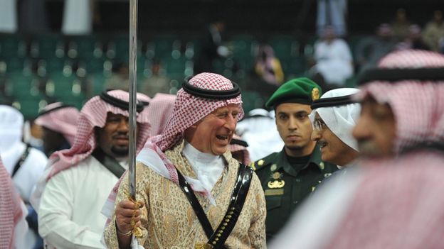 Britain's Prince Charles dances with a sword in traditional Saudi uniform during a visit to Riyadh, the Saudi capital
