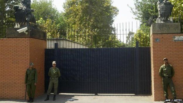 Iranian soldier stands guard in front of the main gate of the British embassy in 2003