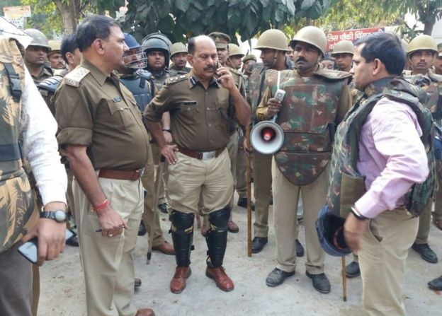 Policemen gather outside a police station following reports of mob violence at Chingrawati village in Bulandshahr