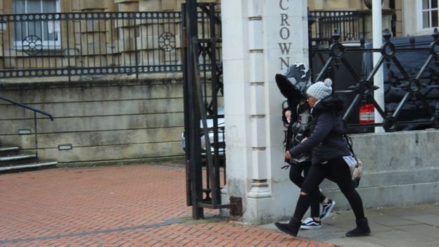 Ms Cordice, wearing hood, enters court