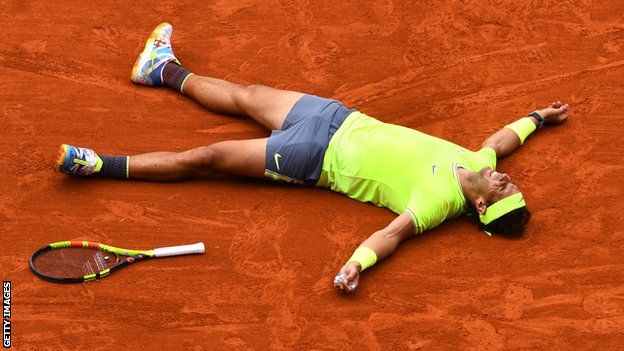 Nadal lies on the ground in celebration