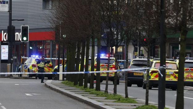 Police officers at the scene after a man was shot and killed by armed police Police officers at the scene after a man was shot and killed by armed police