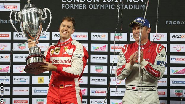 Sebastian Vettel is applauded by runner-up Tom Kristensen of Denmark after winning the Race of Champions at the Olympic Stadium