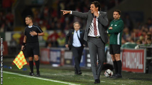 Chris Coleman and match officials during Wales v Austria in 2017