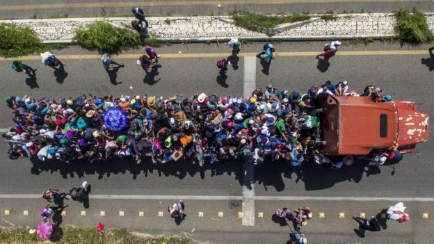 Image shows an eerial view of Honduran migrants onboard a truck as they take part in a caravan heading to the US