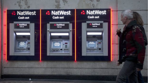 This picture shows people walking past a branch of a NatWest Bank in London