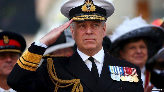 Britain"s Prince Andrew salutes the marching Armed Forces as he attends the Armed Forces Day in Guildford