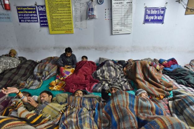 People sleep in a night shelter on a cold winter night at Jama Masjid, on December 28, 2019 in New Delhi, India.