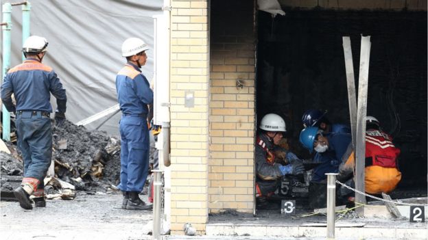 Investigators inspect the scene of the fire at Kyoto Animation