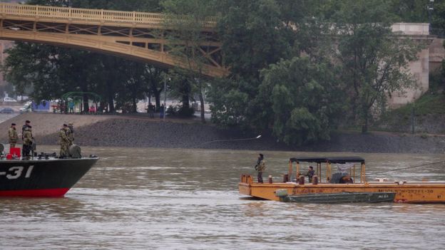 Hungarian authorities search for remains from a tourist boat that capsized on the Danube