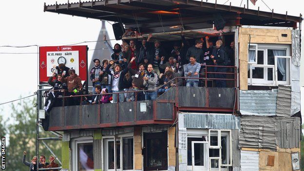 St Pauli fans celebrate taking the lead over Dortmund in a 2010 Bundesliga game from a makeshift stand