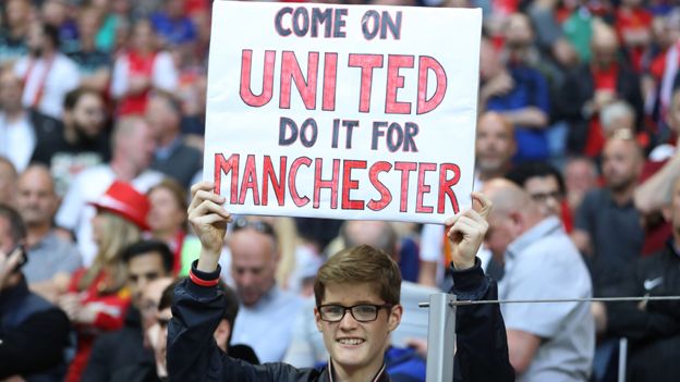 Manchester United fan with sign at Europa League final