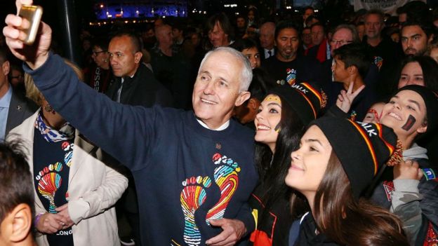 Malcolm Turnbull taking a selfie with two sports fans
