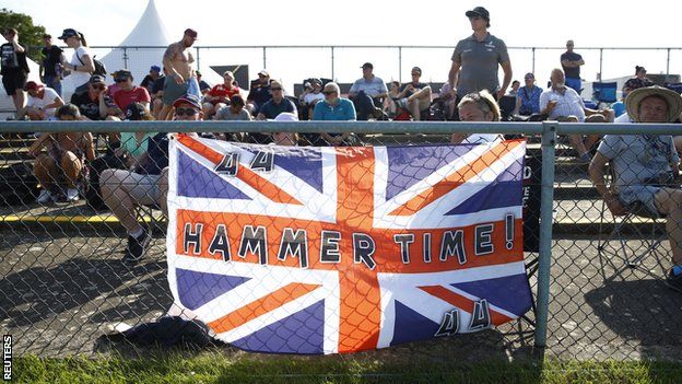 Fans hang a Lewis Hamilton flag