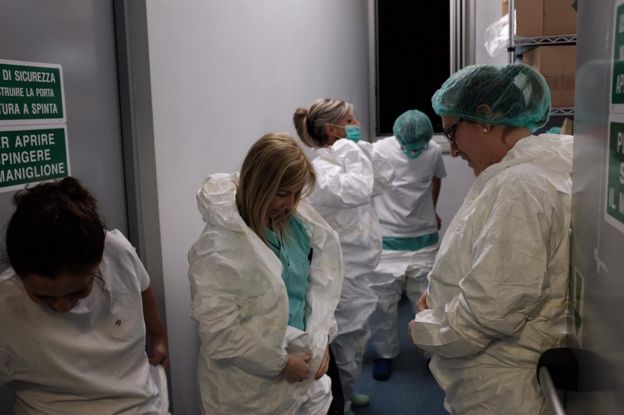 Hospital staff put on protective clothing