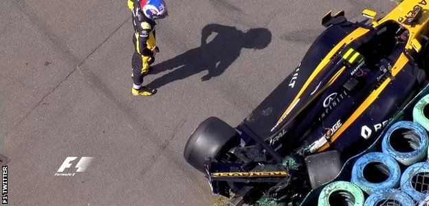 Jolyon Palmer surveys the damage to his car after losing the rear at the final corner