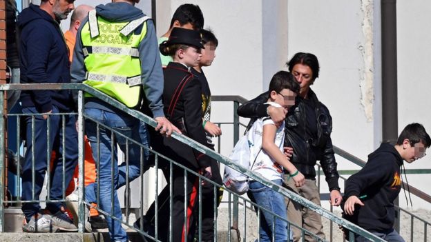 Students leave with their parents after being rescued from a hijacked bus in Milan, Italy, 20 March 2019