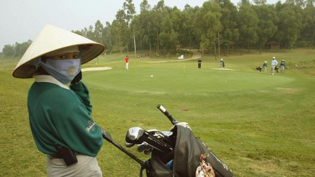 Female worker at a golf course in Vietnam