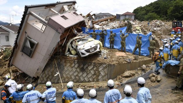 Police and Ground Self-Defense Force's rescue workers inspect damage caused by heavy rains in Kumano, Hiroshima Prefecture, Japan, 09 July 2018.