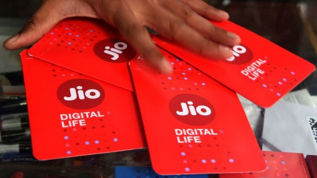 A shopkeeper collects JIO simcards at a mobile phone store in Mumbai on July 19, 2017. Indian oil-to-telecom conglomerate Reliance Industries's first-quarter consolidated profit jumped 28 percent July 20, pumped up by higher margins from its core oil refining business it said, beating analyst estimates.