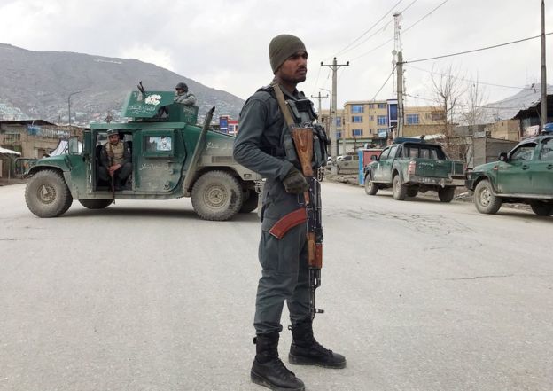 An Afghan policeman stands guard near the site of an attack in Kabul, Afghanistan March 25, 2020