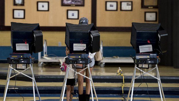 man at electronic voting machine
