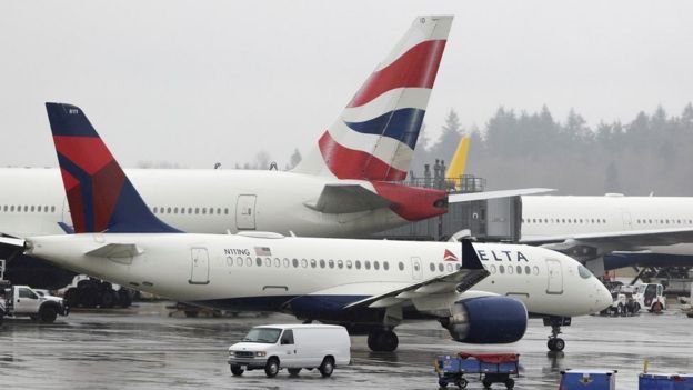 FILE PHOTO: Delta Airlines planes and a British Airways plane (2nd L) are pictured at Seattle-Tacoma International Airport,