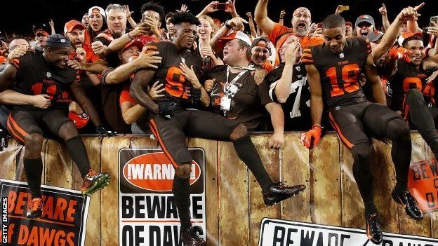 Cleveland Browns players celebrate with fans