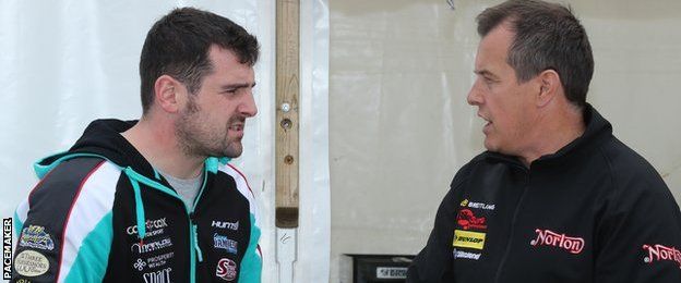 Michael Dunlop and John McGuinness chat shortly before the start of practice at the Isle of Man TT