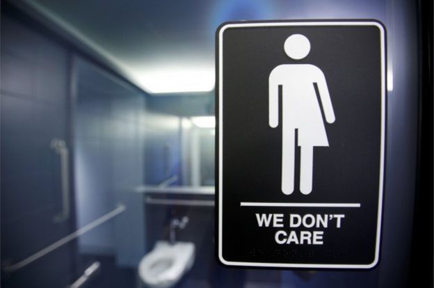 A sign protesting a recent North Carolina law restricting transgender bathroom access adorns the bathroom stalls at the 21C Museum Hotel in Durham, North Carolina, 3 May 2016