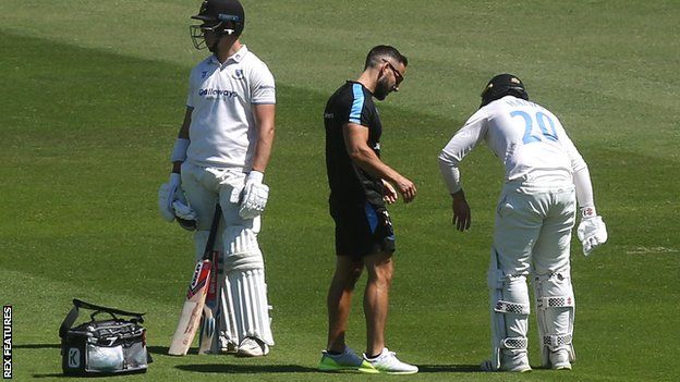Sussex batter Tom Haines receives treatment after hurting his hand