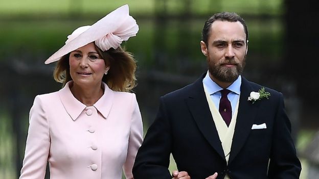 James Middleton, brother of the bride, walks with his mother Carole Middleton as they attend the wedding of Pippa Middleton and James Matthews