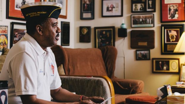 Joe Geeter at his Montford Point Marines office, images of military memorabilia on the walls