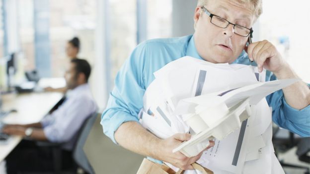 Businessman carry messy sheaf of papers
