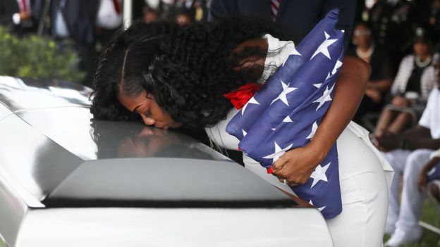 Myeshia Johnson weeping on her husband's coffin at his funeral in Hollywood, Florida on 21 October