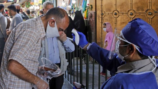 A man has his temperature checked at the entrance to Tehran's Abdol Azim shrine on 25 May 2020