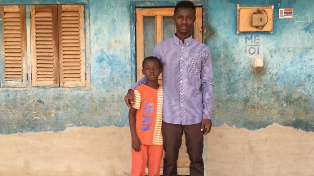 Martin Kyere with his son Elvis at the family home in central Ghana