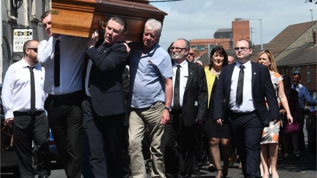 Family and friends carry Seamus Ruddy's coffin