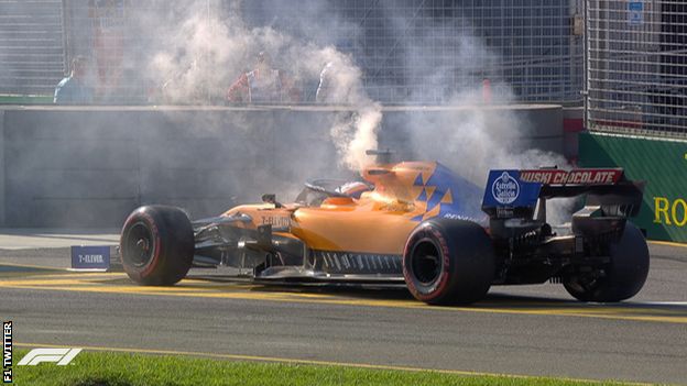 Smoke comes out of Carlos Sainz's McLaren