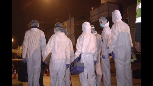 Emergency staff outside the club in Lima