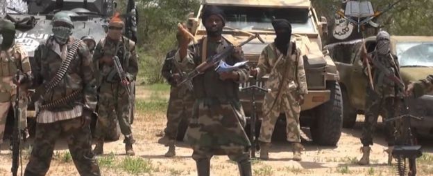 A screengrab taken on 13 July 2014 from a video released by the Nigerian Islamist extremist group Boko Haram and obtained by AFP shows the leader of the Nigerian Islamist extremist group Boko Haram, Abubakar Shekau (C).