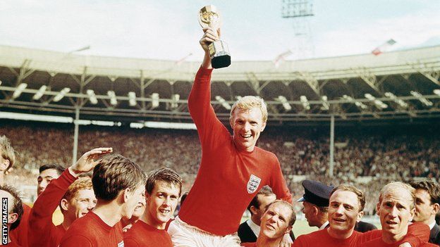 Moore celebrates with the trophy and his England team-mates