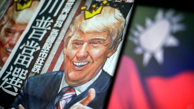 A newspaper headline with the illustration of US President-elect Donald Trump is pictured next to the flag of Taiwan in Taipei, Taiwan, 12 December 2016