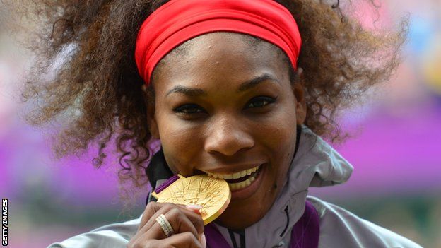 Serena Williams bites the gold medal she won in the London 2012 Olympic Games singles