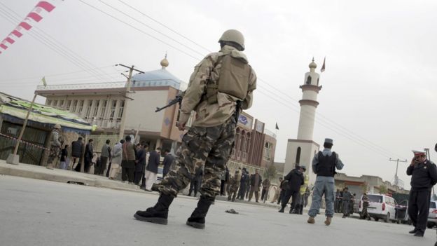 Afghan security forces and and civilians walk around the Shiite Baqir-ul Ulom mosque after a suicide attack inside it, in Kabul, Afghanistan, on 21 November 2016