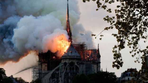 Flames and smoke are seen billowing from the roof at Notre-Dame Cathedral in Paris on April 15, 2019