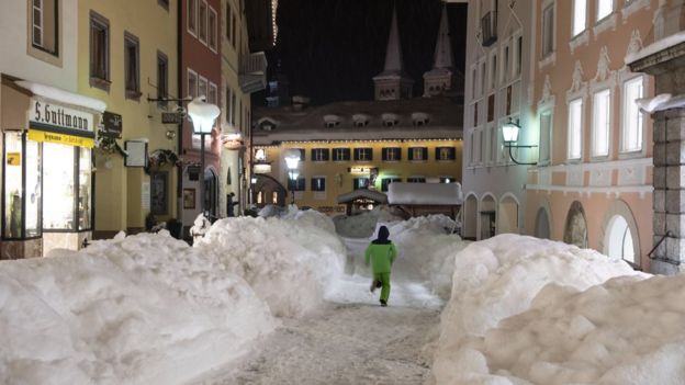 A boy runs through the snow-covered town centre of Berchtesgaden, Bavaria, Germany, 10 January 2019