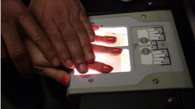 A Chinese immigrant is fingerprinted during her 'biometrics' appointment to receive a green card at the U.S. Citizenship and Immigration Services (USCIS).